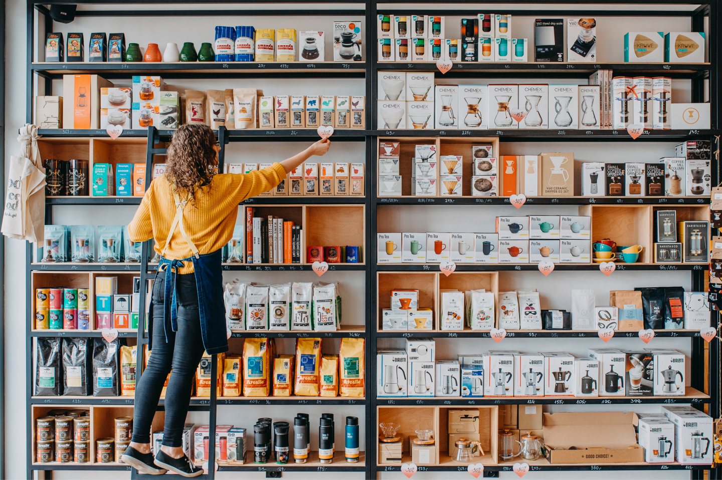 Specialty coffee bags arranged on in-store shelves — the in-person browsing experience the site needed to recreate